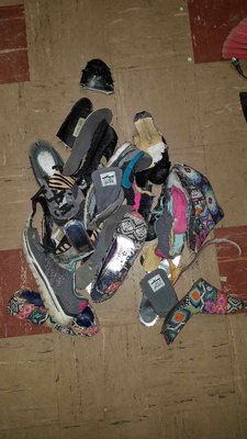 Pile of destroyed old worn out shoes